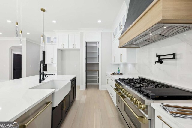 3057 Bold Springs Rd, Dacula, GA 30019 - kitchen with double oven range, a sink, custom range hood, glass insert cabinets, and white cabinetry