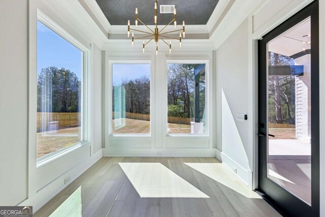 3057 Bold Springs Rd, Dacula, GA 30019 - unfurnished sunroom with a notable chandelier, wood finished floors, visible vents, and a healthy amount of sunlight