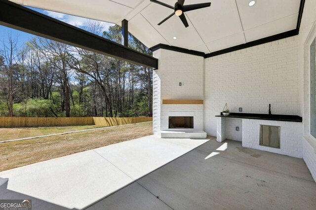 3057 Bold Springs Rd, Dacula, GA 30019 - view of patio / terrace with exterior fireplace, ceiling fan, and fence