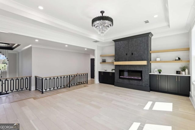 3057 Bold Springs Rd, Dacula, GA 30019 - living area featuring a tray ceiling, a notable chandelier, visible vents, and light wood finished floors