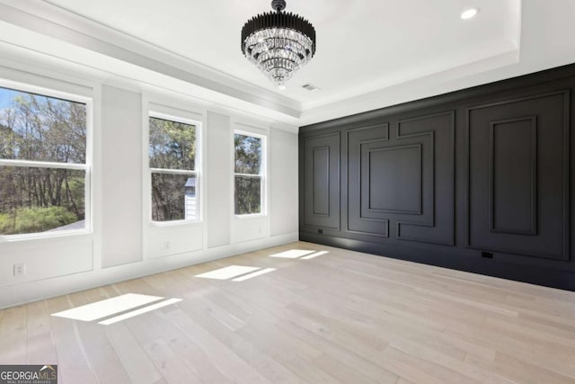 3057 Bold Springs Rd, Dacula, GA 30019 - unfurnished bedroom with a decorative wall, a tray ceiling, a chandelier, wood finished floors, and recessed lighting