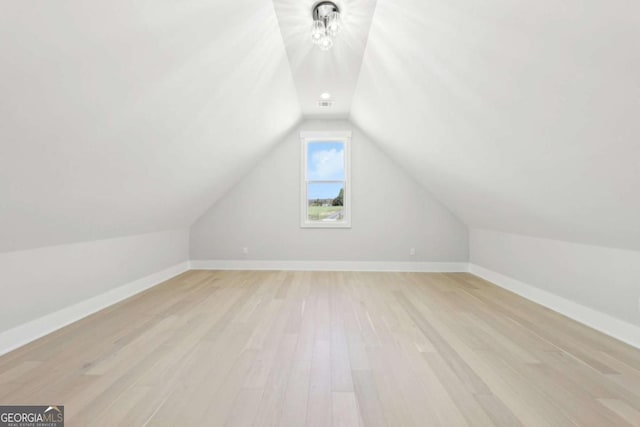 3057 Bold Springs Rd, Dacula, GA 30019 - additional living space featuring visible vents, light wood-type flooring, baseboards, and vaulted ceiling