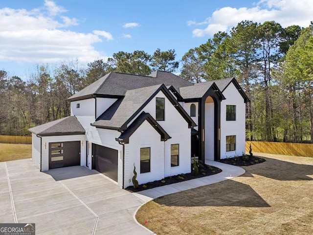 3057 Bold Springs Rd, Dacula, GA 30019 - view of front of house featuring stucco siding, fence, roof with shingles, concrete driveway, and an attached garage