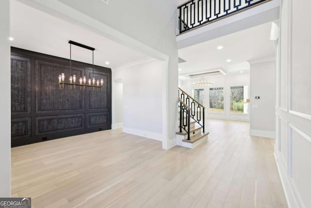 3057 Bold Springs Rd, Dacula, GA 30019 - entryway with stairway, wood finished floors, baseboards, an inviting chandelier, and ornamental molding