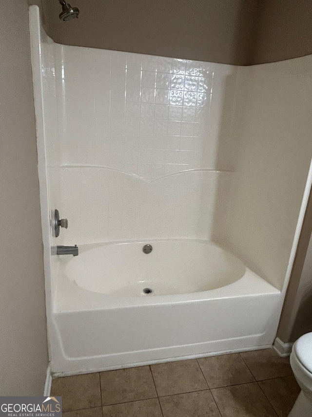 bathroom featuring toilet and tile patterned flooring
