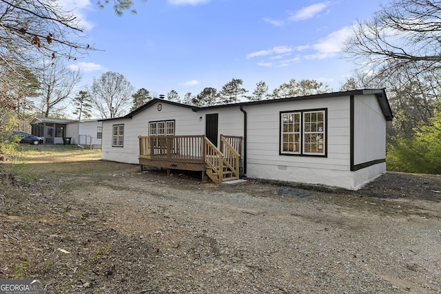 view of front of house featuring crawl space and a wooden deck