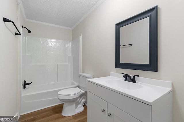 bathroom with toilet, vanity, ornamental molding, wood finished floors, and a textured ceiling