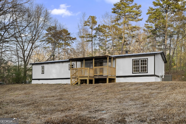 manufactured / mobile home with crawl space, central AC unit, a wooden deck, and metal roof