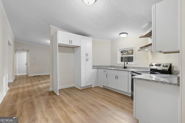 kitchen with light wood finished floors, open shelves, electric range, a sink, and white cabinetry