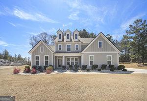 view of front facade with board and batten siding and a front yard