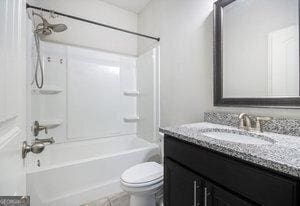 full bath with shower / washtub combination, toilet, and vanity