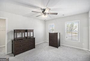 bedroom featuring baseboards, ceiling fan, and carpet flooring