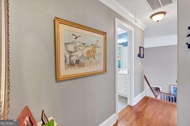 16 Quarter Horse Dr NW, Rome, GA 30165 - hall with baseboards, ornamental molding, an upstairs landing, visible vents, and wood finished floors