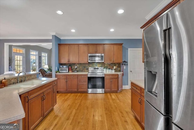 16 Quarter Horse Dr NW, Rome, GA 30165 - kitchen with a sink, brown cabinetry, light countertops, and stainless steel appliances