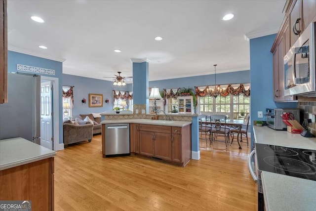 16 Quarter Horse Dr NW, Rome, GA 30165 - kitchen featuring light wood-style floors, ornamental molding, appliances with stainless steel finishes, light countertops, and open floor plan