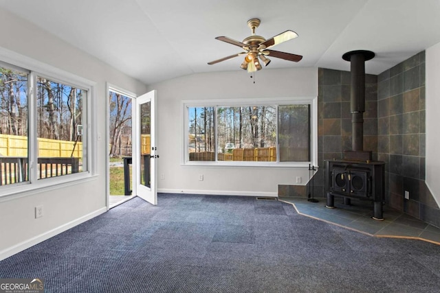1833 Lost Mountain Rd, Powder Springs, GA 30127 - unfurnished living room featuring baseboards, carpet floors, ceiling fan, and a wood stove