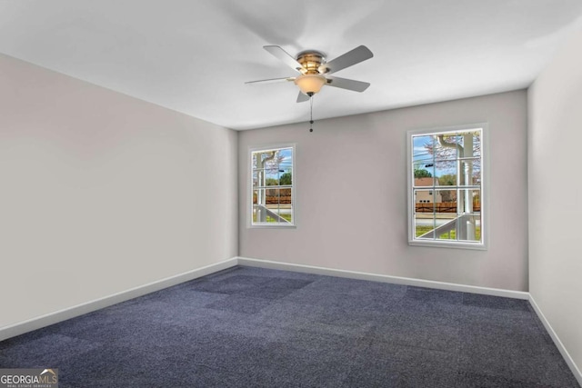 1833 Lost Mountain Rd, Powder Springs, GA 30127 - spare room with baseboards, ceiling fan, and dark colored carpet
