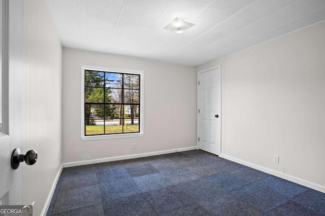 1833 Lost Mountain Rd, Powder Springs, GA 30127 - unfurnished room with baseboards and dark carpet