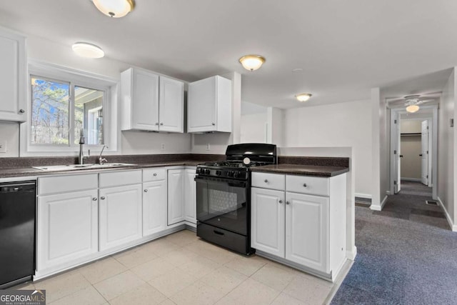 1833 Lost Mountain Rd, Powder Springs, GA 30127 - kitchen with dark countertops, black appliances, a peninsula, white cabinetry, and a sink
