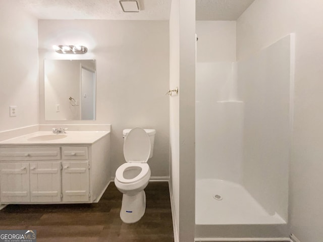 105 Creekwood Ln, Fayetteville, GA 30214 - full bath featuring vanity, wood finished floors, a shower stall, a textured ceiling, and toilet