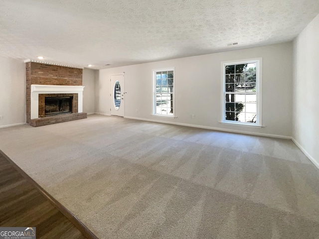 105 Creekwood Ln, Fayetteville, GA 30214 - unfurnished living room featuring a brick fireplace, baseboards, and carpet floors