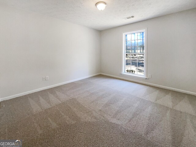 105 Creekwood Ln, Fayetteville, GA 30214 - spare room with baseboards, visible vents, a textured ceiling, and carpet
