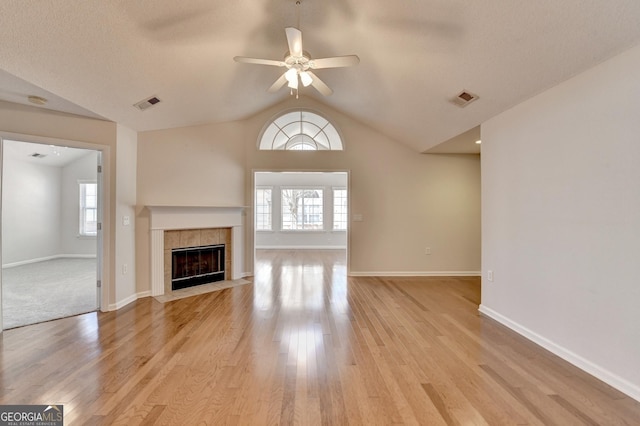 unfurnished living room with visible vents, light wood-style flooring, and a ceiling fan