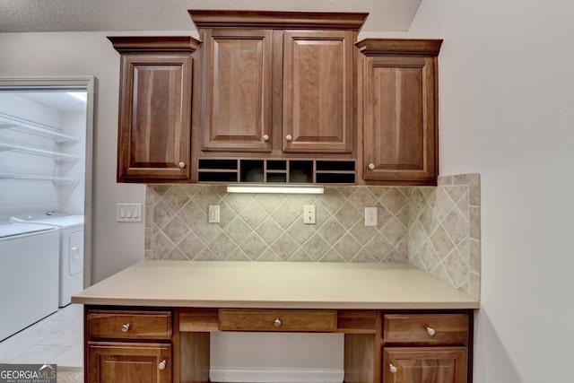 kitchen with built in desk, open shelves, light countertops, and separate washer and dryer