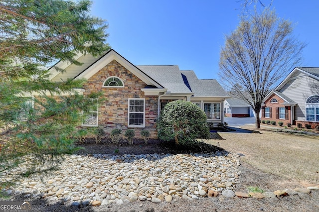 view of front of property with stone siding and a garage