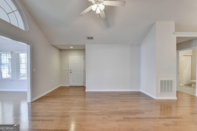 unfurnished room with baseboards, visible vents, light wood finished floors, and ceiling fan