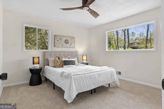 bedroom featuring visible vents, baseboards, and carpet