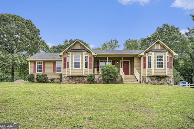 ranch-style house featuring a porch and a front yard