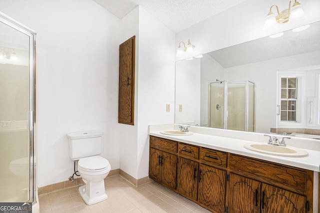 full bathroom with a sink, tile patterned floors, a shower stall, and toilet