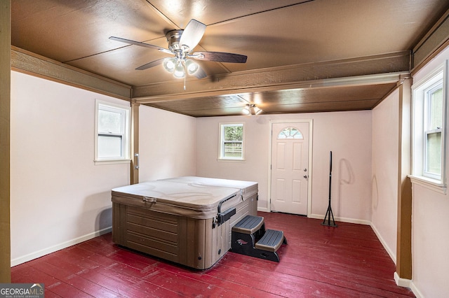 bedroom featuring baseboards, ceiling fan, and dark wood-type flooring