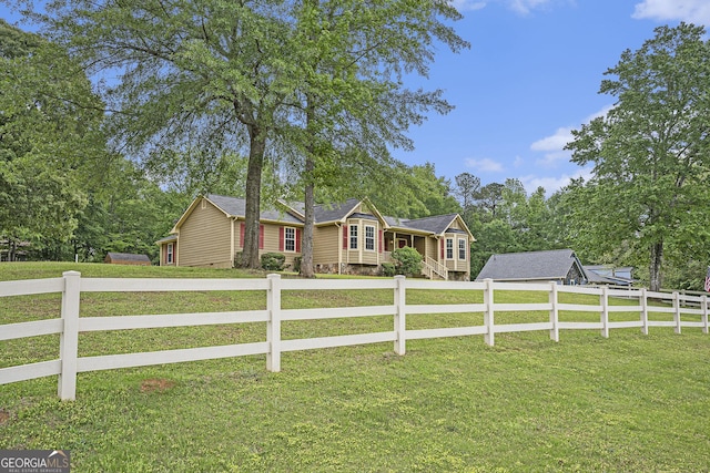 ranch-style house featuring driveway, fence private yard, and a front lawn