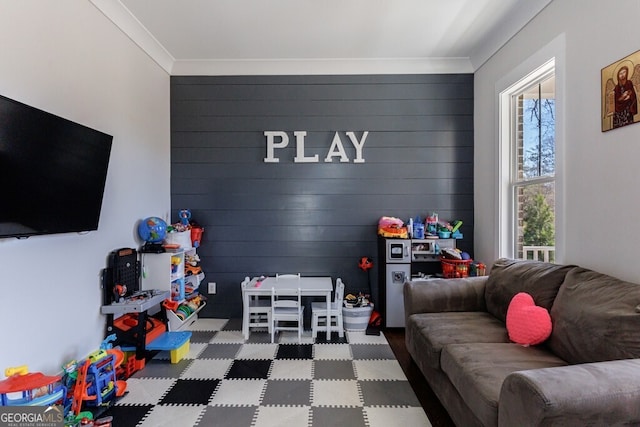 playroom featuring ornamental molding and tile patterned floors