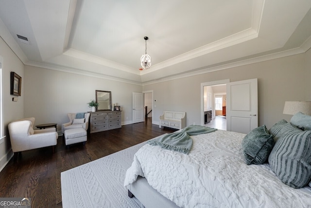 bedroom featuring ornamental molding, a raised ceiling, visible vents, and dark wood-style floors