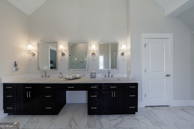 full bath with high vaulted ceiling, double vanity, marble finish floor, and a sink