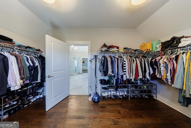 spacious closet with wood finished floors and lofted ceiling