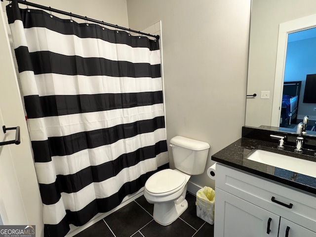 full bath featuring a shower with shower curtain, tile patterned flooring, vanity, and toilet