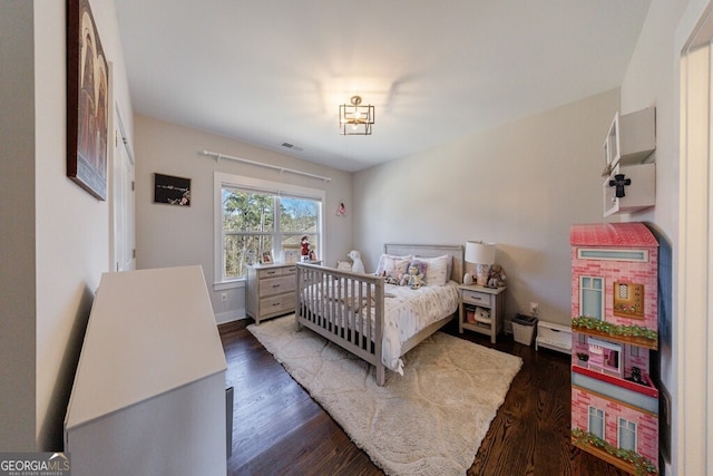 bedroom with dark wood-type flooring and visible vents