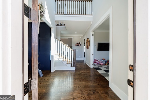 entryway featuring stairs, baseboards, ornamental molding, and wood finished floors