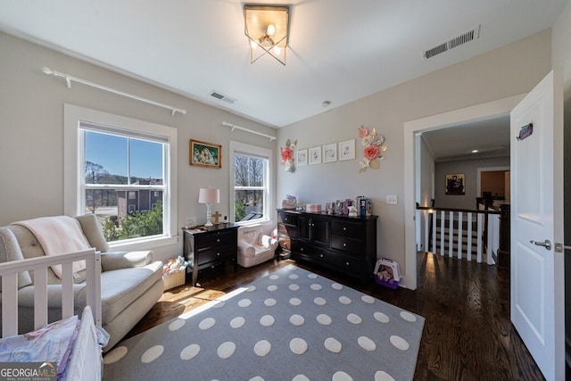 bedroom with visible vents and wood finished floors
