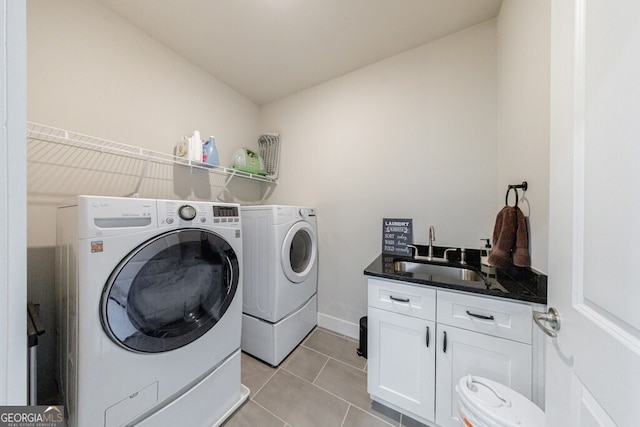 washroom with independent washer and dryer, light tile patterned floors, a sink, and cabinet space