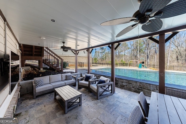 view of patio / terrace featuring an outdoor living space, a fenced backyard, a fenced in pool, and a playground