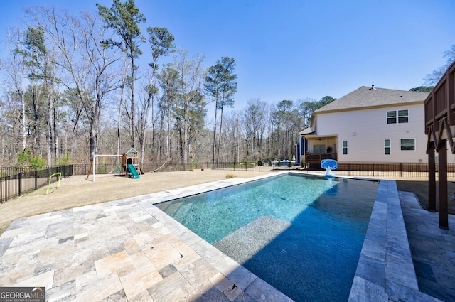 view of swimming pool featuring a fenced in pool, a patio area, a fenced backyard, and a playground