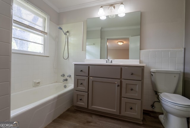 full bathroom featuring crown molding, toilet, wood finished floors, washtub / shower combination, and vanity