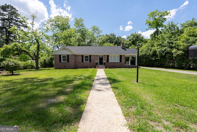 ranch-style house with crawl space, a front yard, brick siding, and a chimney