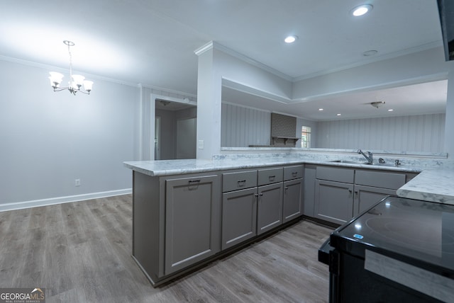 kitchen featuring gray cabinets, black / electric stove, a sink, a chandelier, and ornamental molding