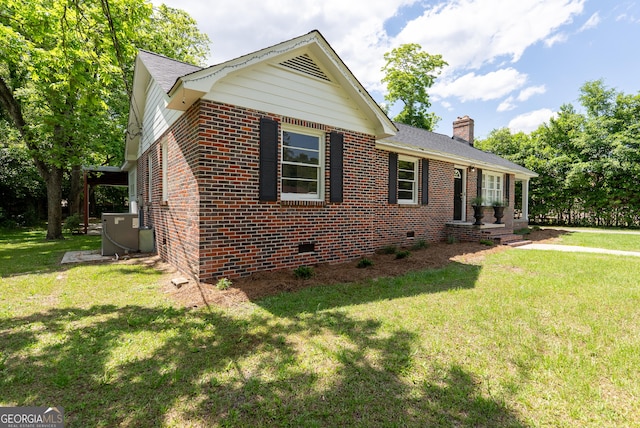 ranch-style house with brick siding, cooling unit, a chimney, and a front lawn